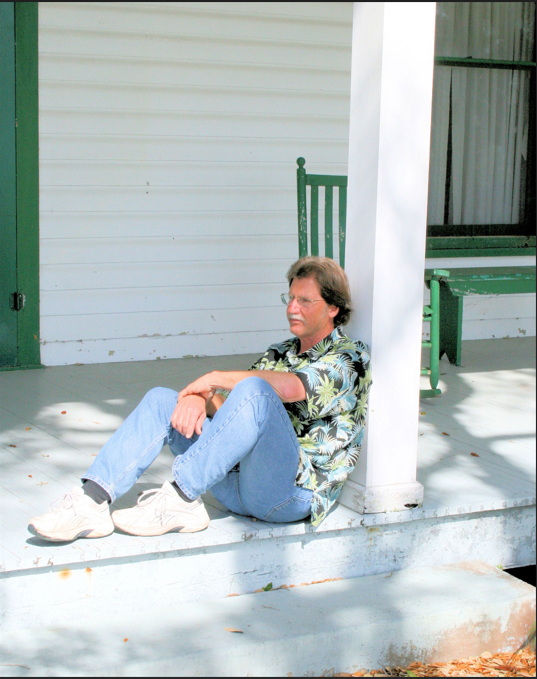 Danny O’Driscoll strikes a modern-day pose on the front porch of the Pacetti Hotel