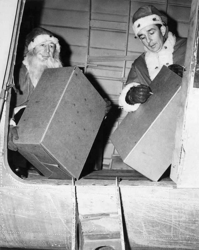 Captain William Wincapaw and son Bill Jr. delivering presents in 1946
